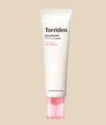A squeeze tube of Torriden Cellmazming Firming Cream with a pink cap, set against a white background with a decorative smear of white cream behind it.
