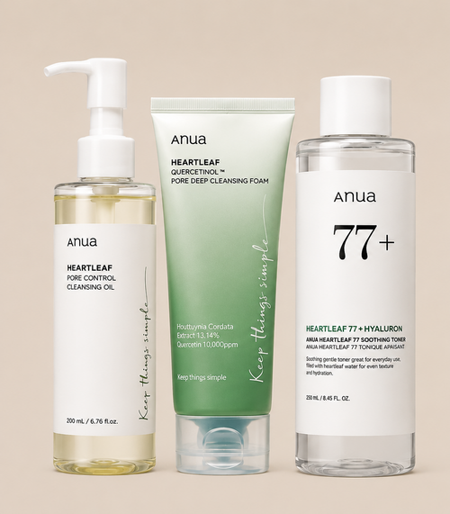 Four Anua skincare bottles and tubes arranged on a warm beige background: a cleansing oil bottle with a pump, a green cleansing foam tube, a clear bottle labeled 77+ with white cap, and a white bottle labeled 70+ with white cap.